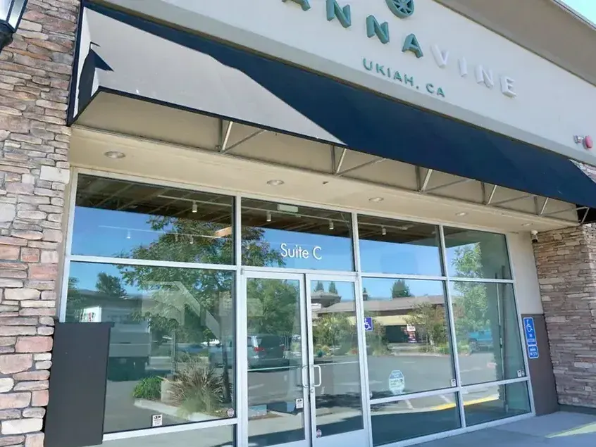 Cannavine Ukiah storefront with stone pillars, awning, and glass doors