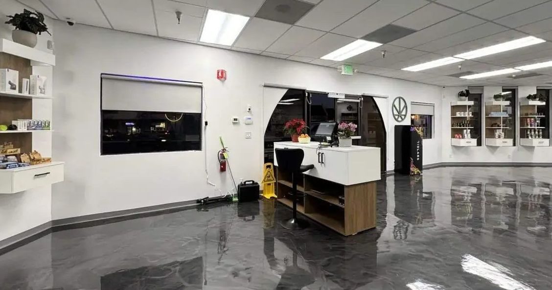 Spacious dispensary interior with polished floors, white walls, and product displays